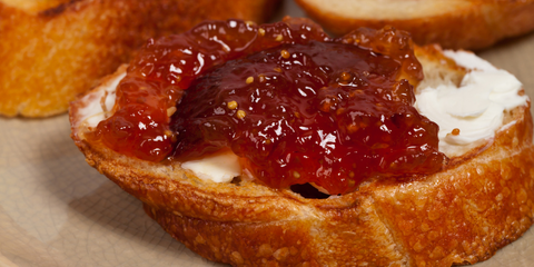 Toasted bread topped with creamy cheese and fig jam